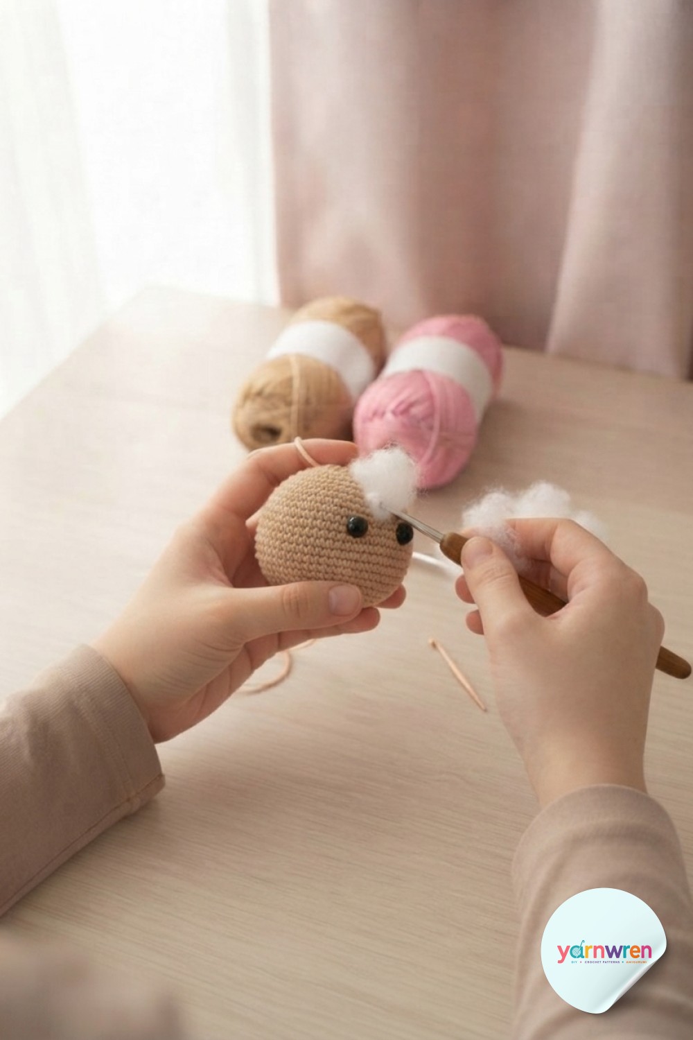 Firmly stuffing the crochet puppy amigurumi head with polyester fiberfill through the last small opening