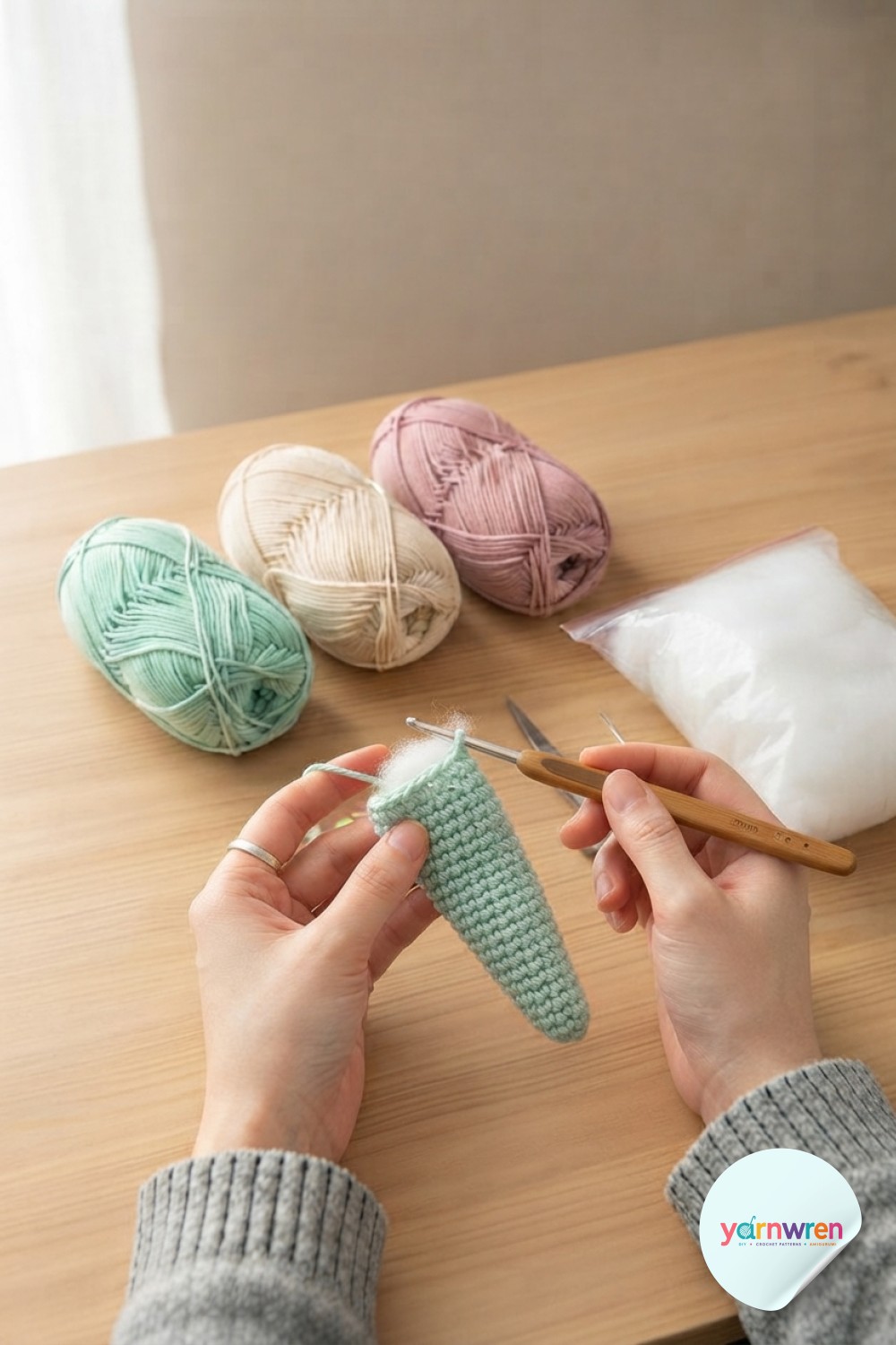 Increase rounds shape the tapered tail of the crochet snake amigurumi pattern, stuffing peeking through.