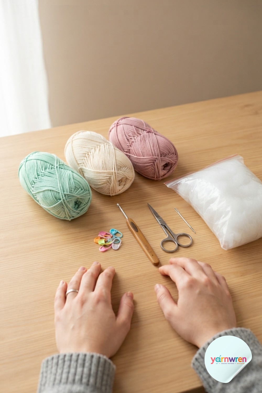 Yarn, hook, stitch markers, and stuffing laid out to begin this crochet snake amigurumi pattern.