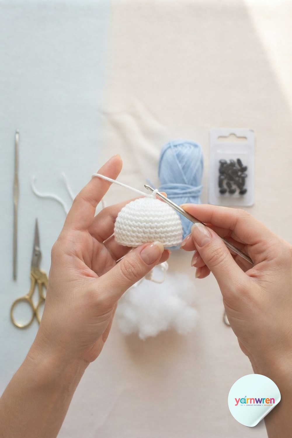Hands beginning jellyfish keychain crochet, shaping the increase rounds of a white amigurumi dome