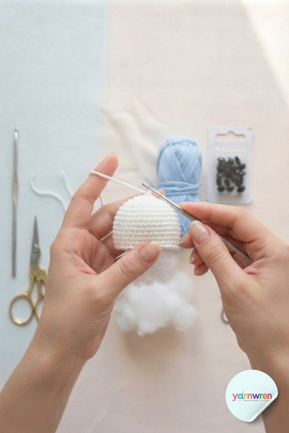 Half-finished white dome for jellyfish keychain crochet with fiberfill stuffing visible inside